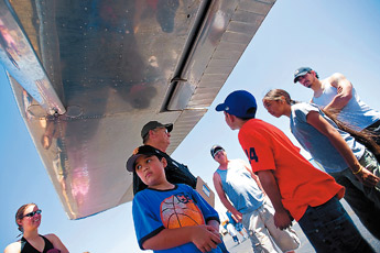 Joesiah Talamante turns to watch another plane take off while taking a tour of Cessna before taking a ride in the plane during the Rocky View Fly In at the Gallup Airport Saturday. &mdash;&nbsp;&copy; 2009 Gallup Independent / Cable Hoover