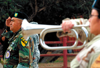 U.S. Army veteran Earl Milford stands at attention while Taps is played for fallen comrades at the Navajo Nation US Veteran's Memorial Park in Window Rock on Monday. "Its hard and it hurts when we remember those that didn't come home," said Milford. &mdash;&nbsp;&copy; 2009 Gallup Independent / Adron Gardner 