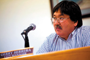 Gallup City Manager Gerry Herrera listens as Councilor E. Bryan Wall asks to have Herrera's termination considered at the next council meeting during Tuesday's meeting at City Hall. &mdash;&nbsp;&copy; 2009 Gallup Independent / Cable Hoover 