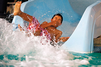 Kyle Baldwin holds his nose as he emerges from the water slide at the Gallup Aquatic Center Wednesday. &mdash;&nbsp;&copy; 2009 Gallup Independent / Cable Hoover