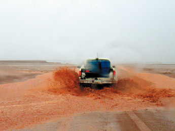 There was no safe drinking water available May 22 at the Black Falls Church water point when Roland Tohannie went to fill up his water barrels, but there was plenty on the road, making travel hazardous. &mdash;&nbsp;&copy; 2009 Gallup Independent / Kathy Helms