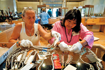 Jill Pulgar and Laveda Buser sort jewelry entries to be put into cases after judging had been completed for the Gallup Inter-Tribal Ceremonial juried Art Show on Monday afternoon. State senators and representatives were in town to took a tour of entries in the Gallup Inter-Tribal Ceremonial Art Show.&mdash;&nbsp;&copy; 2009 Gallup Independent / Brian Leddy 