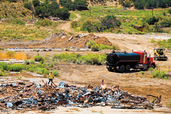 A worker with MACTEC works at the site where a building once stood at United Nuclear Corporation's mine site north of Churchrock. Preliminary work began on the site this week, with the company getting ready to begin removal of hundreds of thousands of tons of contaminated soil. &mdash;&nbsp;&copy; 2009 Gallup Independent / Brian Leddy 
