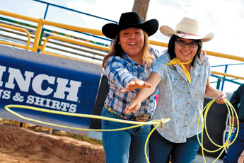 Amber Dawn shows Samantha Cosen how to rope during Friday's Exceptional Children's Rodeo at the Navajo Nation Fair on Friday. The event is an opportunity for children with mental and physical disabilities to experience a piece of the rodeo. &mdash;&nbsp;&copy; 2009 Gallup Independent / Brian Leddy 