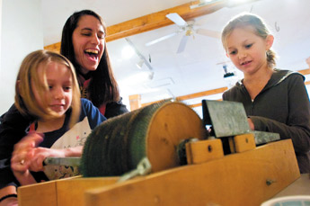 Kate Wilson, center, shows sisters Laney Cangro, left, and Michaela Cangro how to seperate wool with a drum carder during the Fiber Arts Festival at the Old School Gallery near El Morro in this Oct. 11, 2008 file photo. The festival featured exhibits and demos of spinning, weaving, quilting and of other textile arts. &mdash;&nbsp;&copy; 2009 Gallup Independent / Cable Hoover 