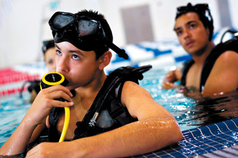 Kevin Langley tests his regulator while preparing to learn new scuba diving skills during the Police Atheletic League's scuba training at the Gallup Aquatic Center Saturday. &mdash;&nbsp;&copy; 2009 Gallup Independent / Cable Hoover 
