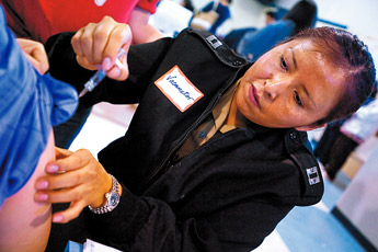 Lt. Carmellita Darwin of the United States Public Health Service gives a flu vaccination Wednesday at the Gallup Community Center. &mdash;&nbsp;&copy; 2009 Gallup Independent / Cable Hoover 