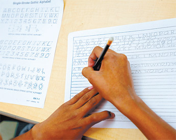 A student works at copying letters during a drafting exercise in his industrial arts class at Chief Manuelito Middle School Wednesday in Gallup. The industrial arts students spend all their time learning drafting techniques because the wood shop has no equipment. &mdash;&nbsp;&copy; 2009 Gallup Independent / Cable Hoover 