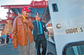 Navajo Code Talker Lloyd Oliver is guided by his grandson, Steve Oliver, to a bus heading to Albuquerque from Fire Rock Casino on Sunday. &mdash;&nbsp;&copy; 2009 Gallup Independent / Adron Gardner 