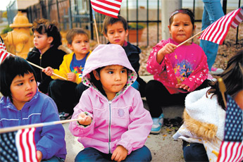 Caley Cheremiah, a preschooler at Bethany Christian, waves a flag with her fellow students during Gallup&rsquo;s Veterans Day parade Wednesday morning. The parade ended with a ceremony at the downtown Courthouse Square. &mdash;&nbsp;&copy; 2009 Gallup Independent / Brian Leddy