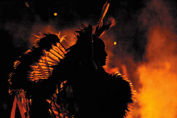 Eight-year-old fancy-dancer Maximus Sheka performs by a bonfire during the Red Rock Balloon Rally Glow in the Rocks at Red Rock Park Friday night. &mdash;&nbsp;&copy; 2009 Gallup Independent / Cable Hoover 