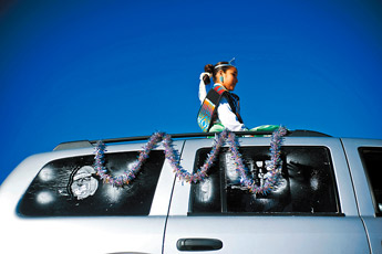 Ft. Defiance Diné Princess Kiana Toadlena rides on top of an SUV during the Snowflake Christmas Parade in Window Rock Saturday. — © 2009 Gallup Independent / Cable Hoover